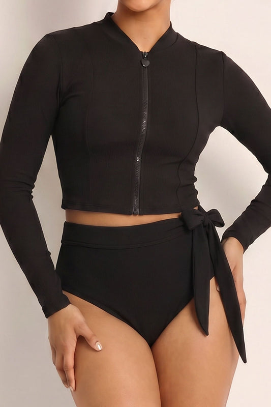 Black long-sleeve swimsuit with a tie detail on a neutral background