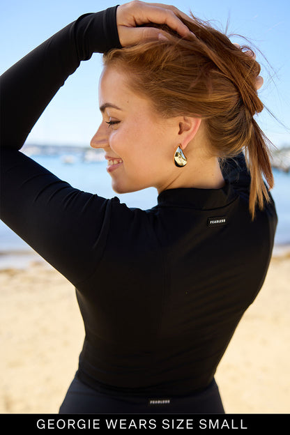Model showcasing the Fearless au Cropped Rashie in Black - a cropped rashguard designed with long-sleeve