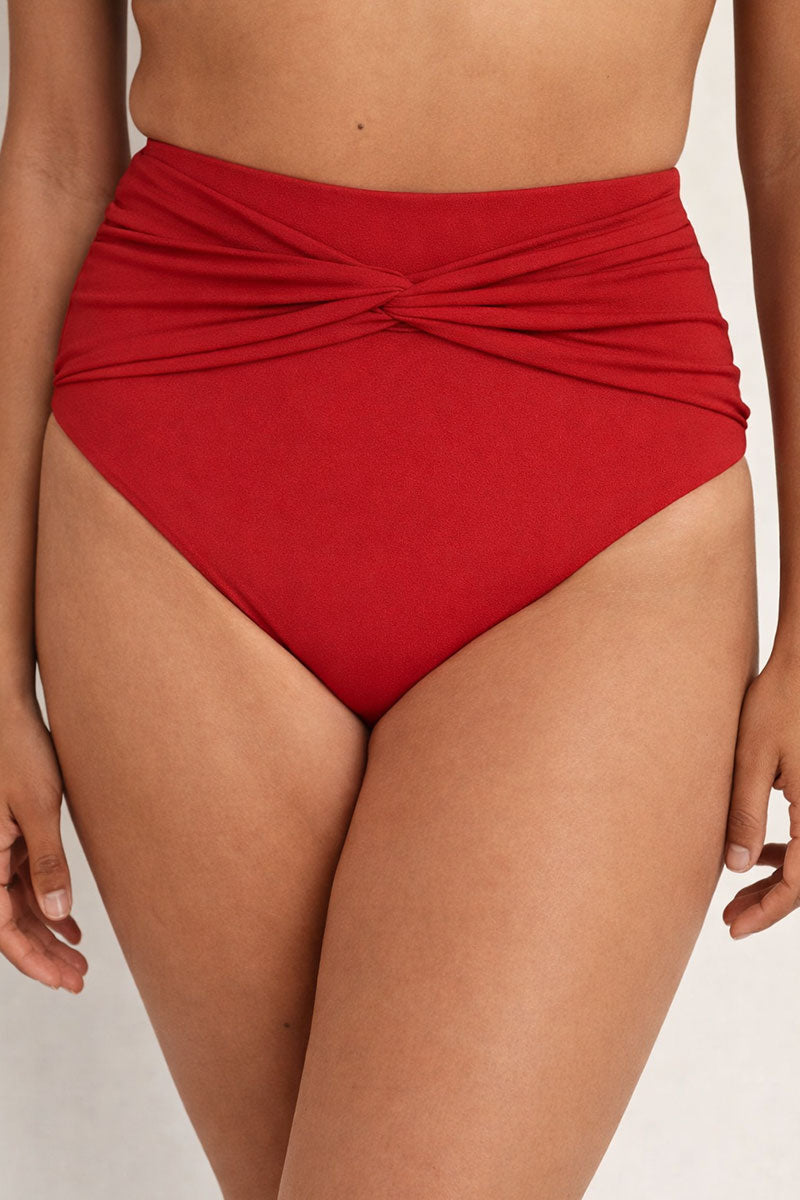 Red high-waisted bikini bottom on a neutral background