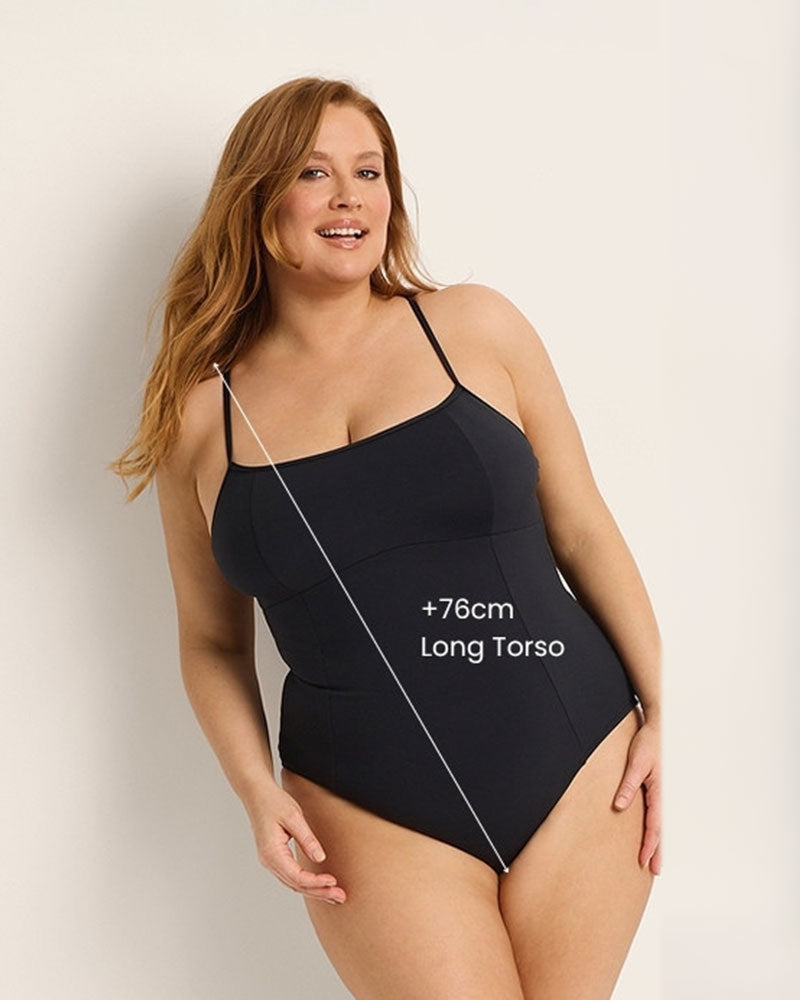 Woman wearing a black swimsuit with text indicating +76cm long torso on a plain background.
