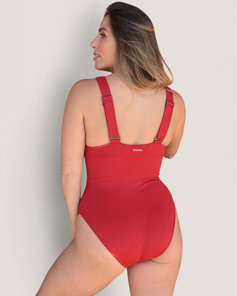 Woman wearing a red swimsuit against a plain background
