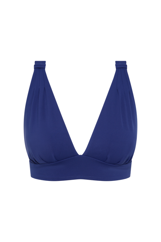 The All Day Bikini Top-Royal Blue by Fearless au is a deep blue wireless top with a plunging V-neckline, wide underband, adjustable straps, and gathered cup details, shown on a plain white background.