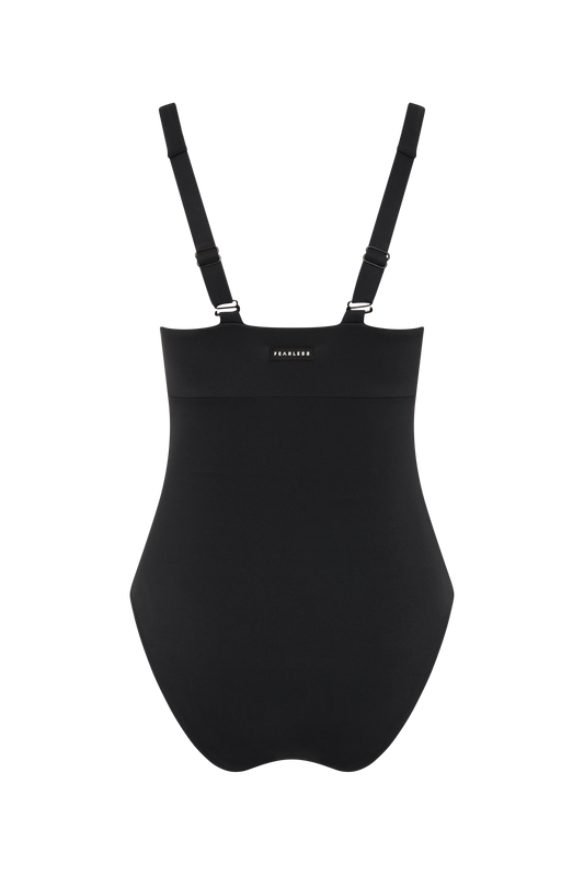 The Magic Suit - Matte Black / Standard by Fearless au is a black shapewear bodysuit with adjustable straps, seamless design, and eco-friendly recycled fabric. “FEARLESS” is printed on the front chest, shown on a white background.