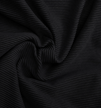 A close-up of black ribbed fabric with a textured corduroy-like surface, shown in soft folds and swirls.