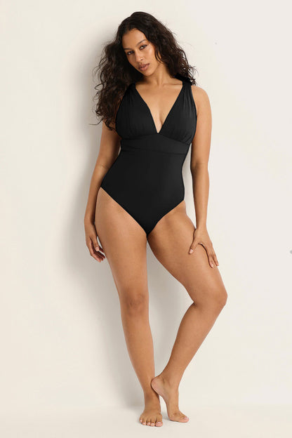 Model showcasing the Fearless au All Day One Piece in Matte Black - a one-piece swimsuit designed with supportive underwire bust