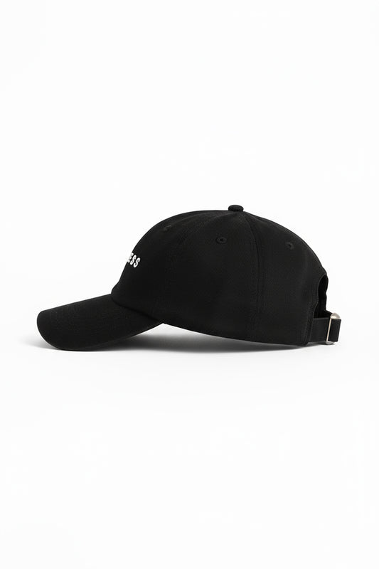 The Fearless Cap by Fearless au, a black baseball cap with a curved brim and adjustable strap, is shown in profile against a white background, displaying its embroidered logo.