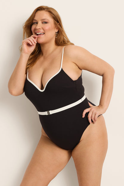Model showcasing the Fearless au Grace High Rise in Matte Black - a one-piece swimsuit designed with high-rise boyleg cut