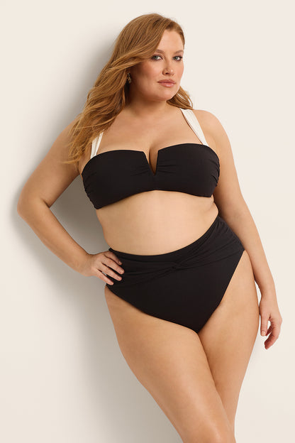 Model showcasing the Fearless au Icon Bikini Bottom in Black - a bikini bottom designed with high-waisted